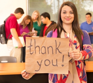 College student with thank you sign